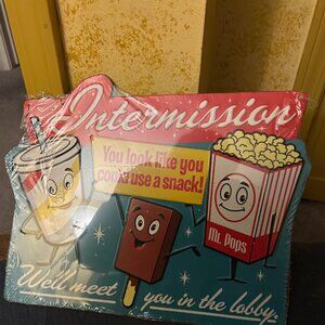 Vintage "Intermission" embossed metal sign "we'll meet you in the lobby" in the